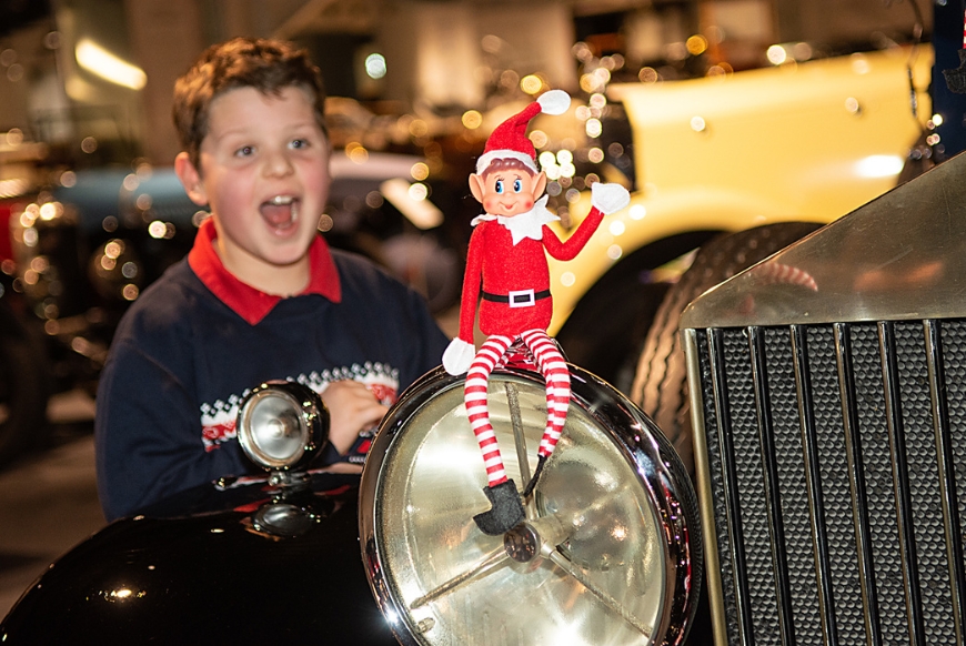 A visitor spots an elf which is part of a Christmas trail at Haynes Motor Museum 